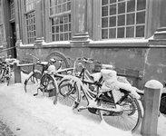 880249 Afbeelding van besneeuwde fietsen, geparkeerd voor het pand Achter St.-Pieter 14 (Boekhandel en Antiquariaat ...